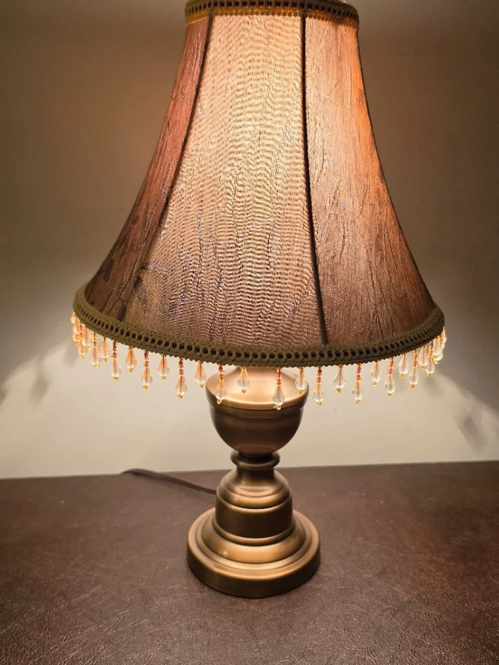 VTG Table Lamp features copper colored metal base with a fabric shade